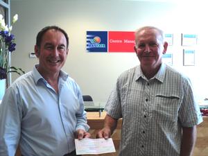 Bayfair centre manager Steve Ellingford presents a cheque for $30,000 to 'Hint Hint' winner David McGee